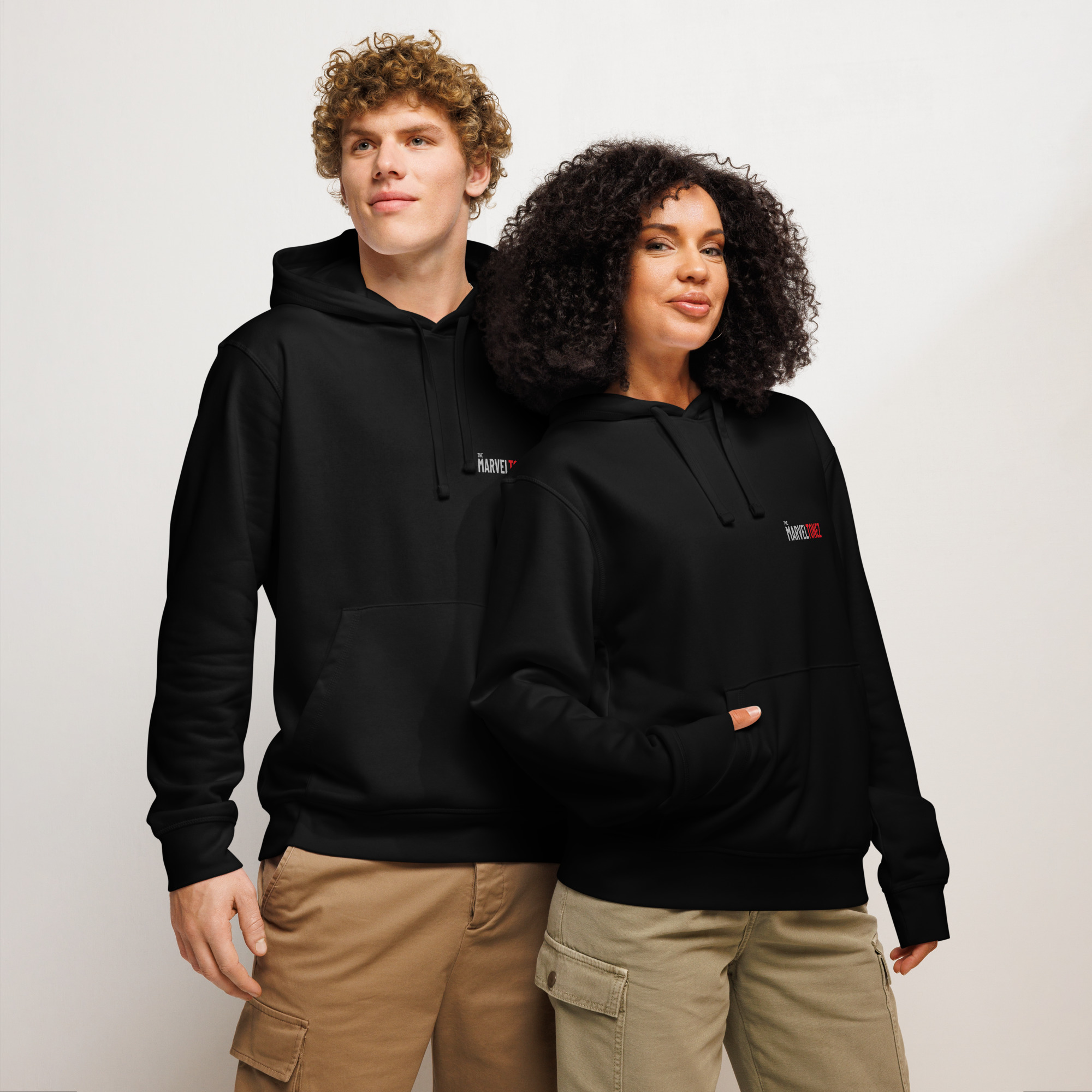 Male and female models wearing the black Marveltonez Studio Hoodie